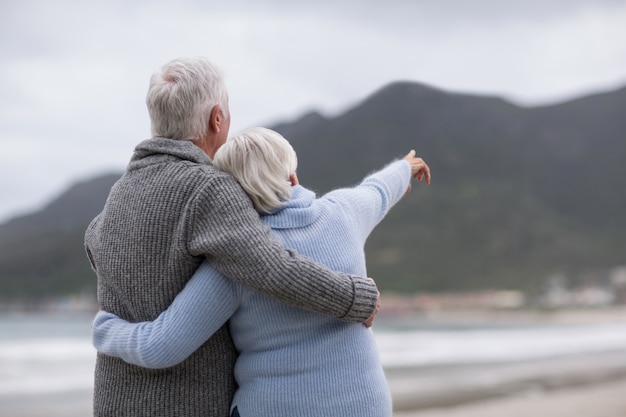 Senior couple embracing each other on the beach