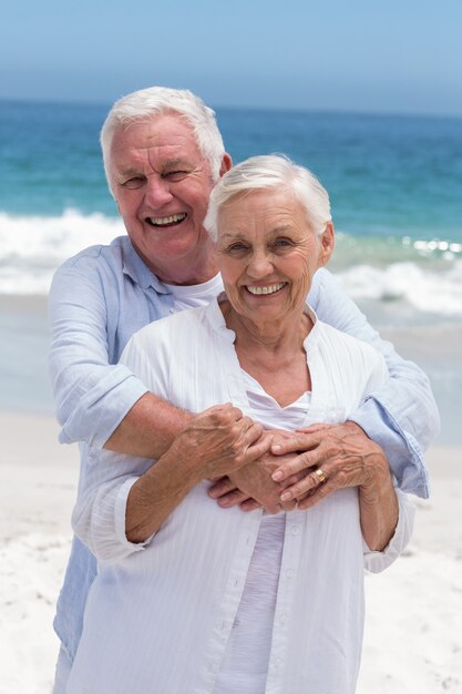 Senior couple embracing with arms around