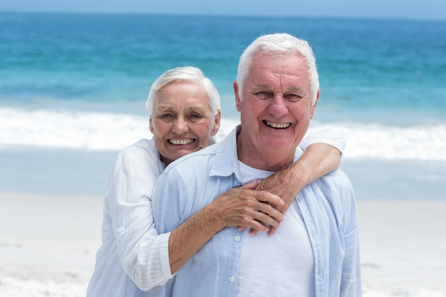 Senior couple embracing with arms around