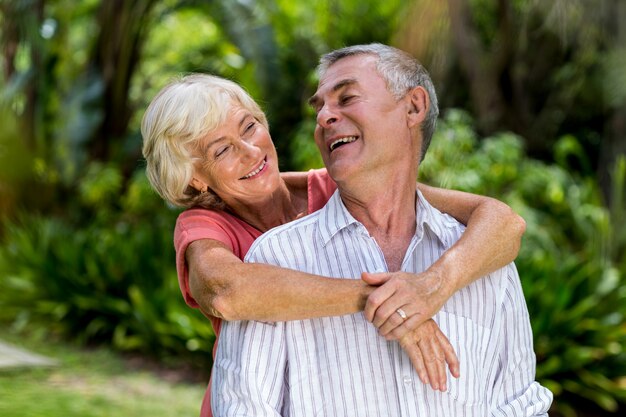 Senior couple embracing in yard