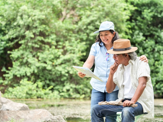 Senior Couple Enjoying Camping trip, They are drink coffee in the morning together.