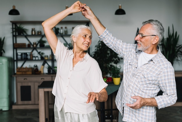 Senior couple enjoying dancing in the home