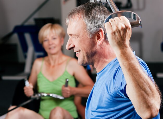 Senior couple exercising at gym