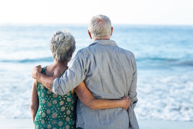 Senior couple facing the sea