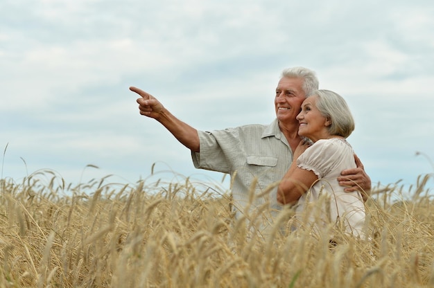 Senior couple on field of wheat