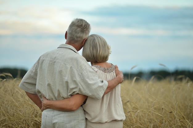 Senior couple on field of wheat