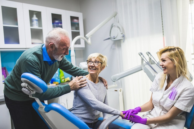 Senior couple having dental treatment at dentist's office.