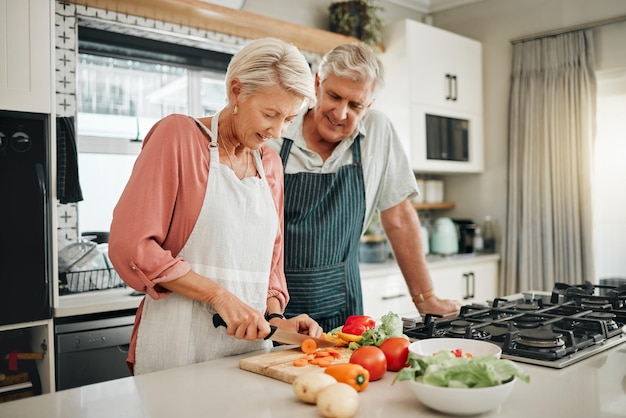 Senior couple healthy food and cooking lunch together in Australia kitchen at home Happy woman hungry man and retirement people cut vegetables for nutrition diet wellness and vegan dinner meal