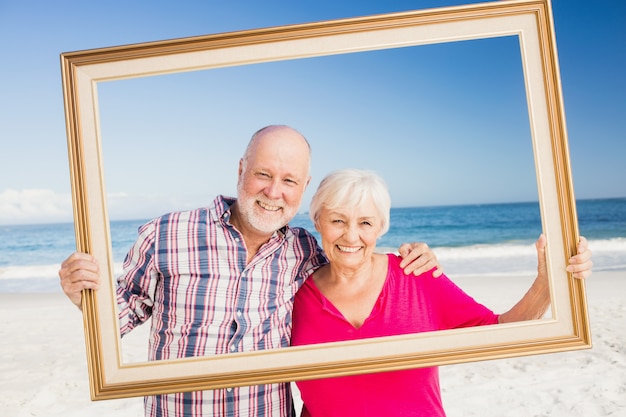 Senior couple holding frame