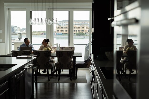 Senior couple interacting with each other while sitting at dining table