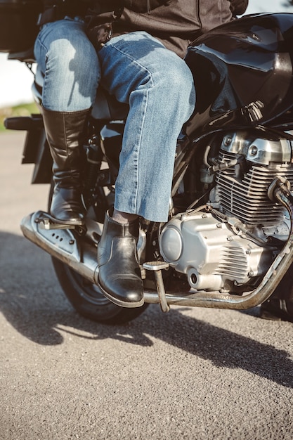 Senior couple legs with boots sitting over motorcycle ready to go