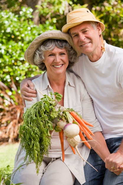 Senior couple looking at the camera in the garden