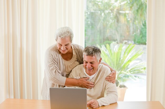 Senior couple looking at their laptop