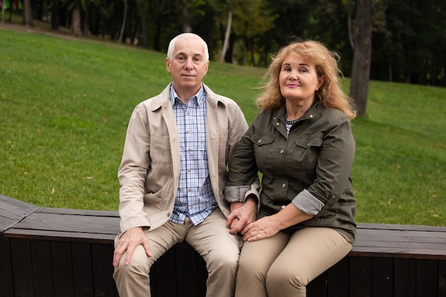 Senior couple in love in the park in autumn or outdoors day