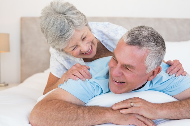 Senior couple lying in bed