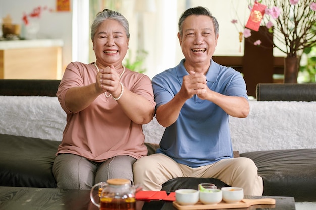 Senior Couple Making Greeting Gesture