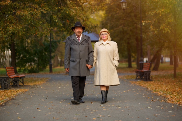 Senior couple in the park on an autumns day