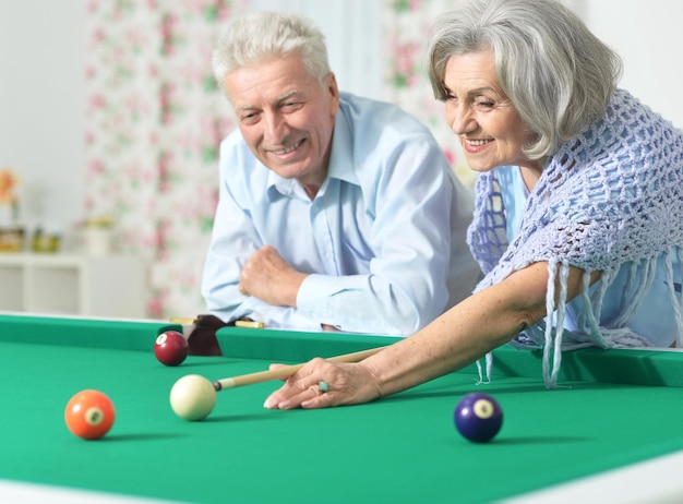 Senior couple playing billiard