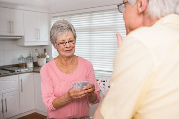 Senior couple playing cards at the counter