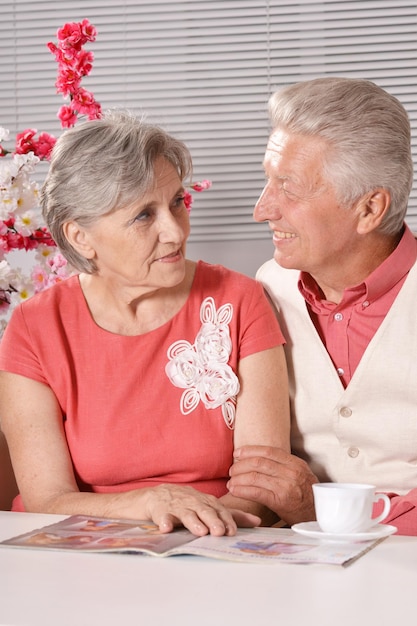 Senior couple reading magazine