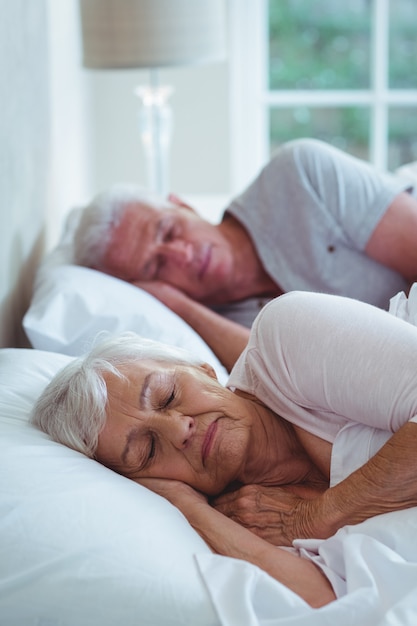 Senior couple relaxing on bed 