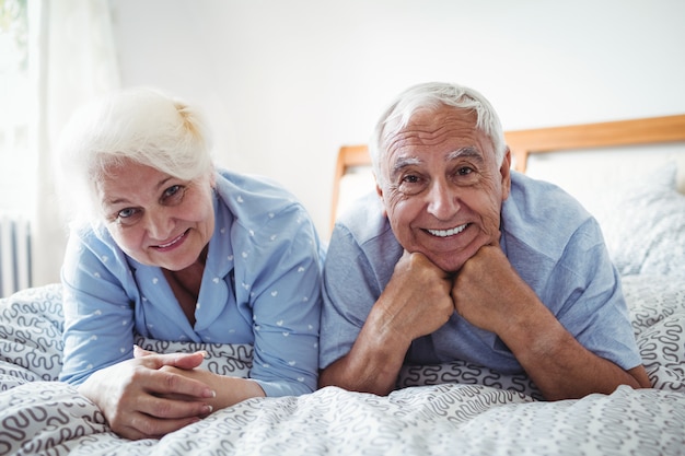 Senior couple relaxing on bed