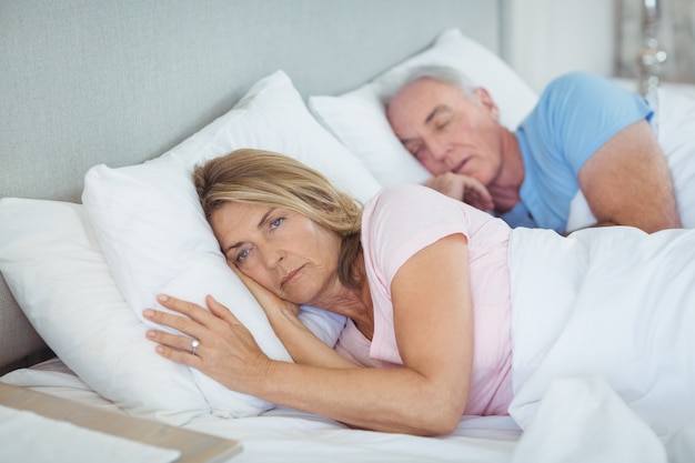 Senior couple relaxing on bed