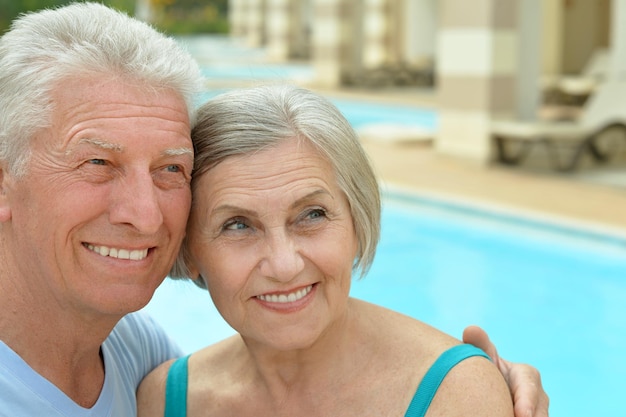 Senior couple relaxing at pool