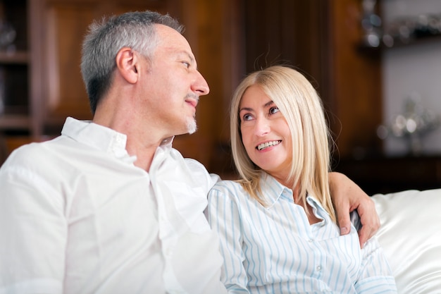  Senior Couple Relaxing On Sofa At Home 