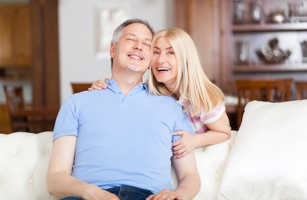  Senior Couple Relaxing On Sofa At Home 