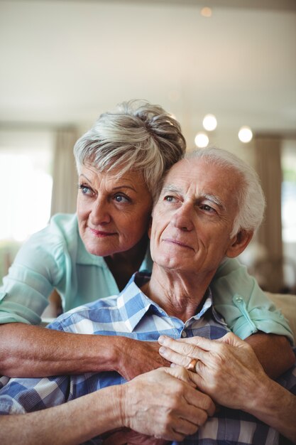 Senior couple relaxing on sofa in living room