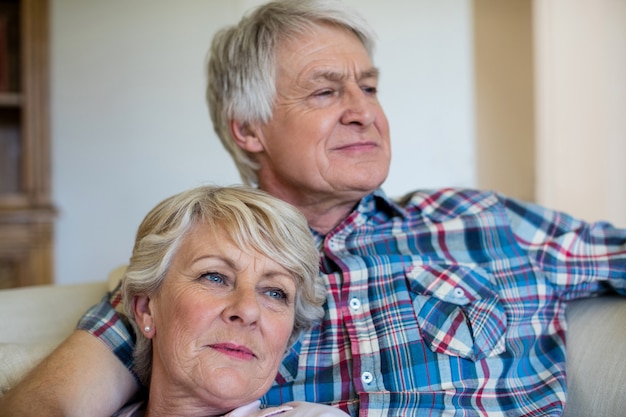 Senior couple relaxing on sofa in living room