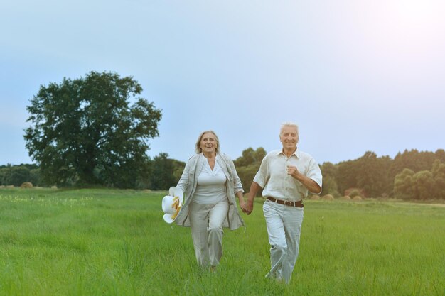 Senior couple running on the field