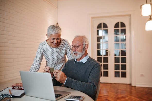 Senior couple shopping online at home