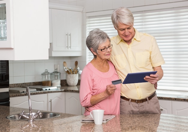 Senior couple shopping online with tablet pc