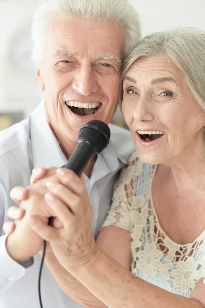 Senior couple singing karaoke
