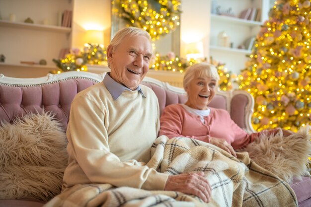 Senior couple sitting on couch together