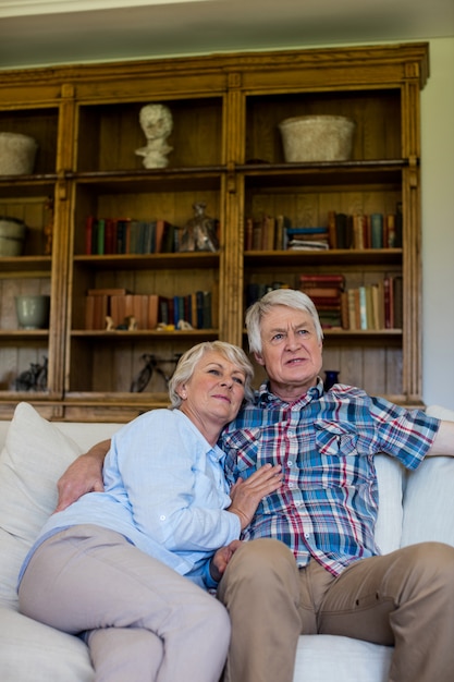 Senior couple sitting together on sofa