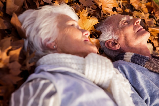 Senior couple sleeping on the ground