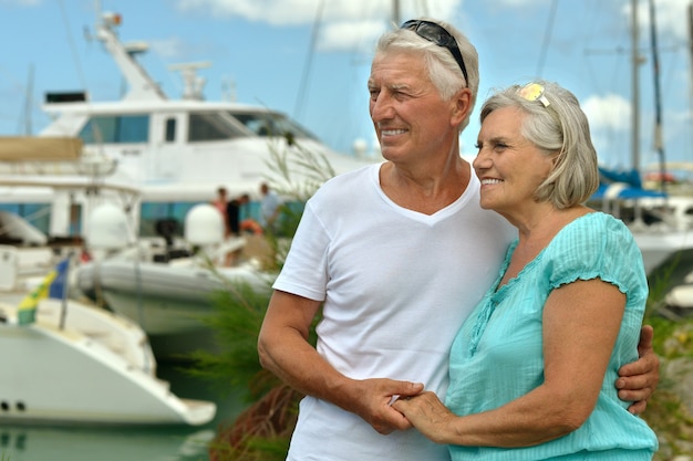 Senior couple standing on pier at the resort during vacation