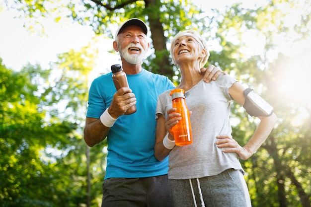 Senior couple staying hydrated after running jogging