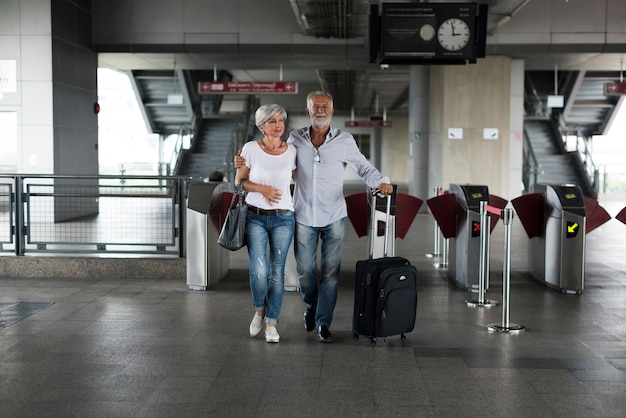 Senior couple traveling train ticket gate