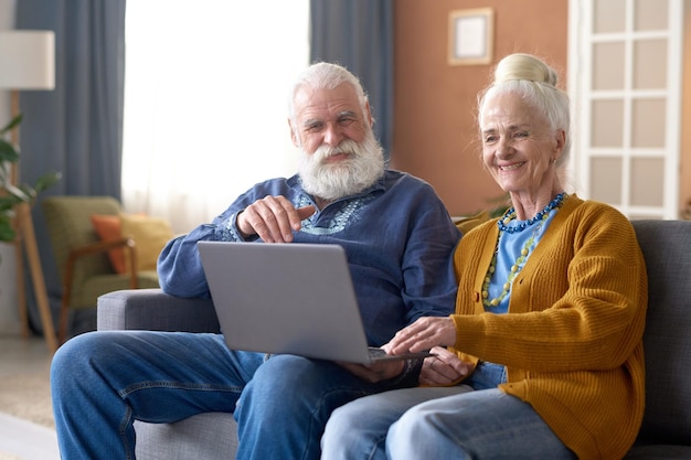 Senior couple using laptop at home