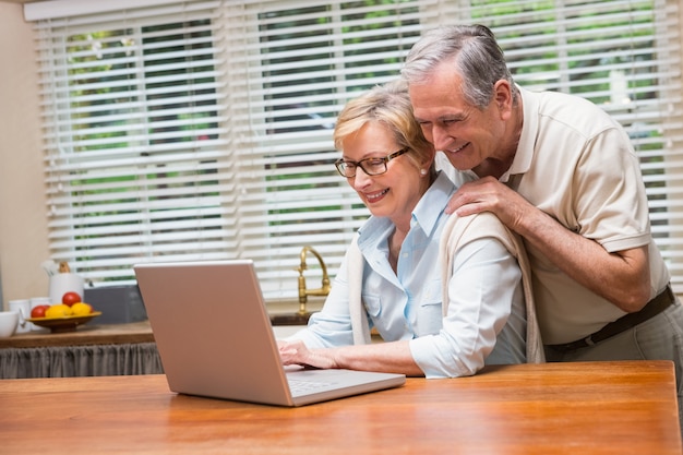 Senior couple using the laptop together