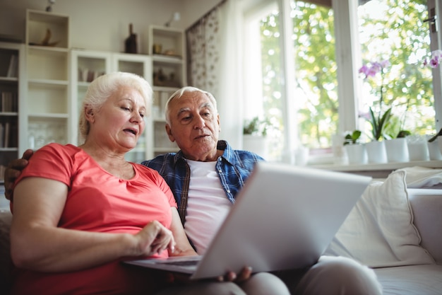 Senior couple using laptop