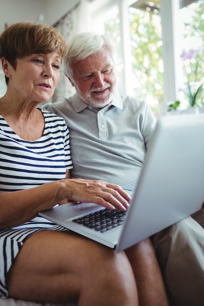 Senior couple using laptop