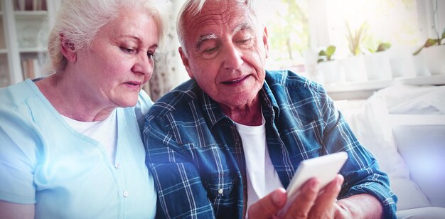 Senior couple using mobile phone