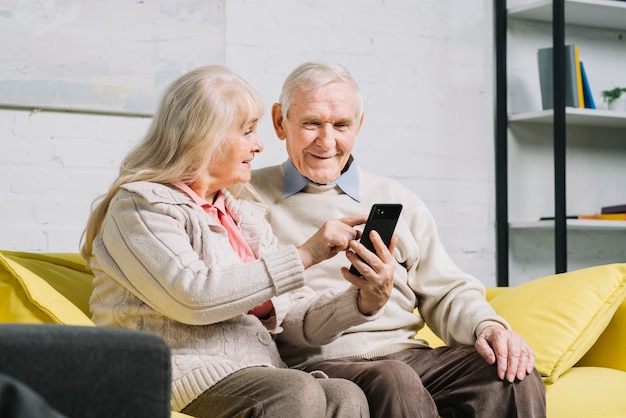 Senior couple using smartphone