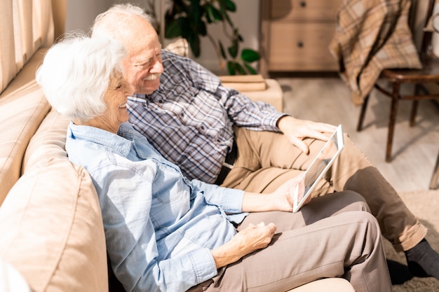 Senior Couple Using Tablet Side View