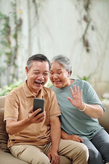 senior couple video calling grandchildre